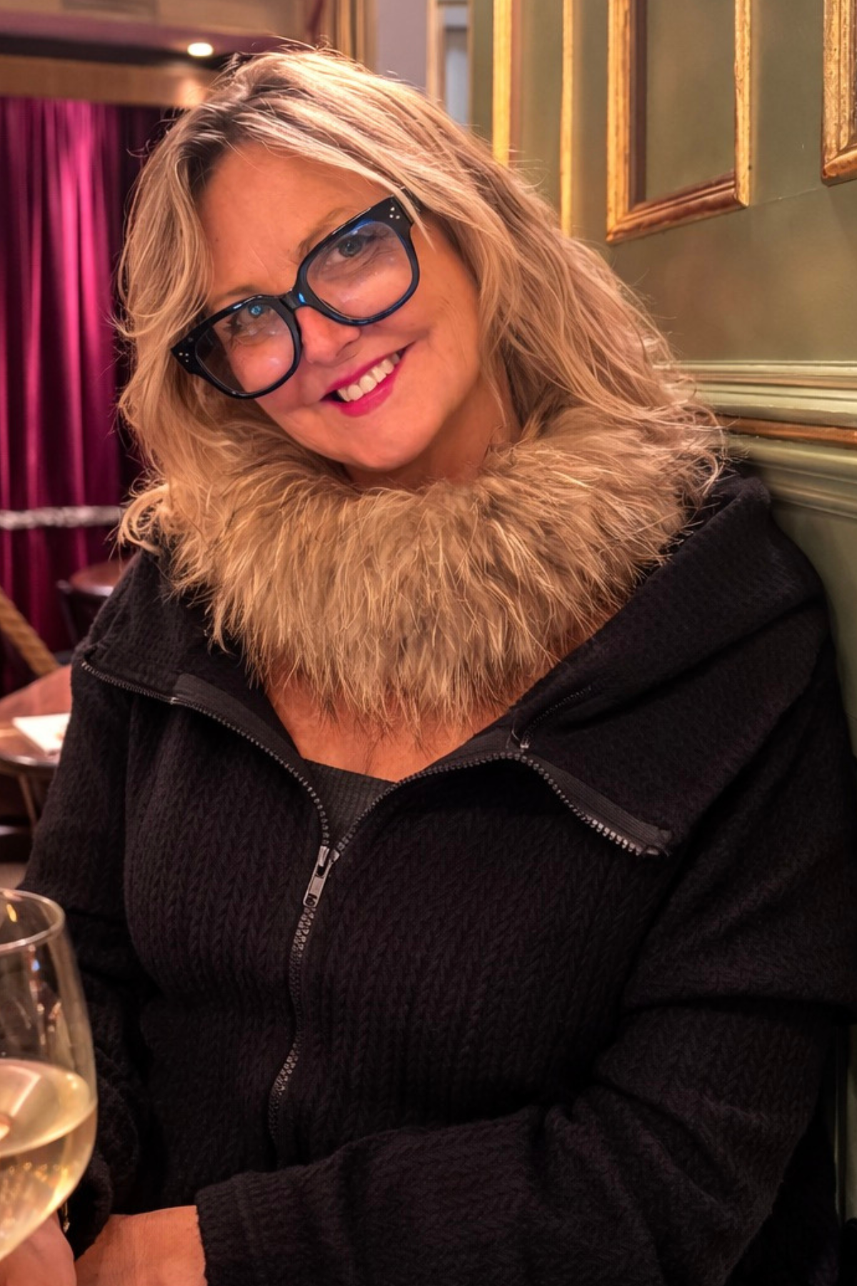 Kim wearing black knitted convertible hoodie travel outfit 