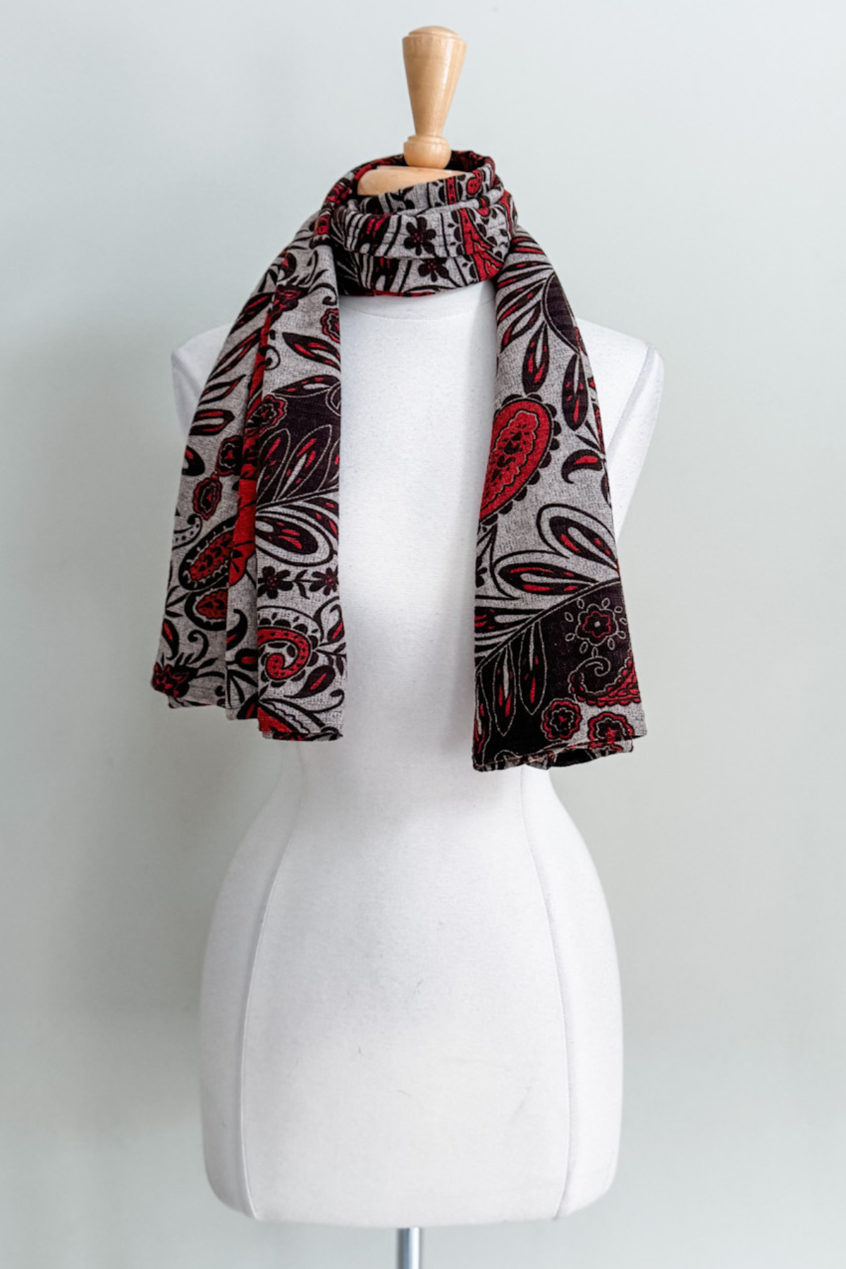 Diane Kroe Carry-on Cozy in red Spain print styled as scarf.