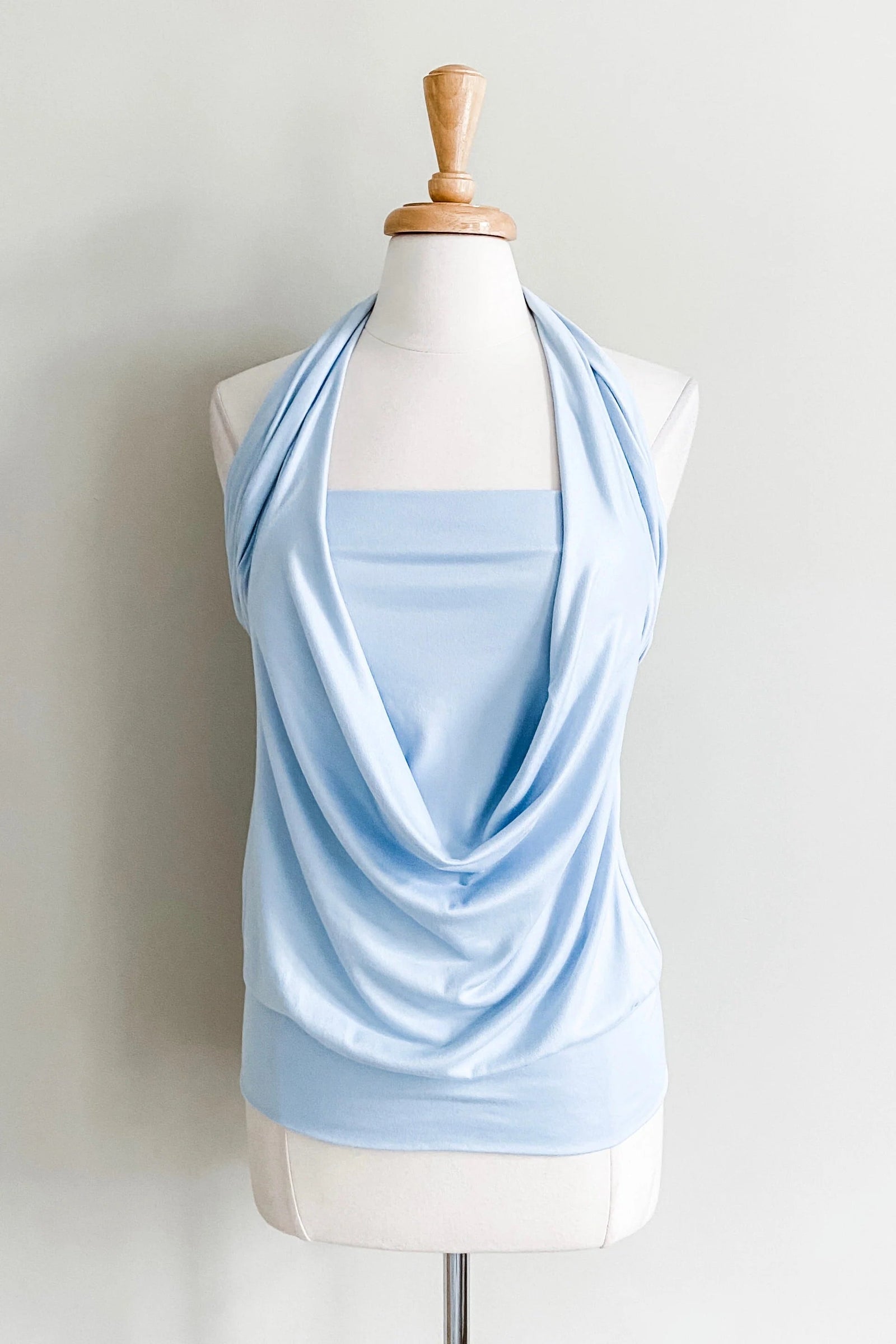 Light blue sleeveless top on a mannequin against a plain background