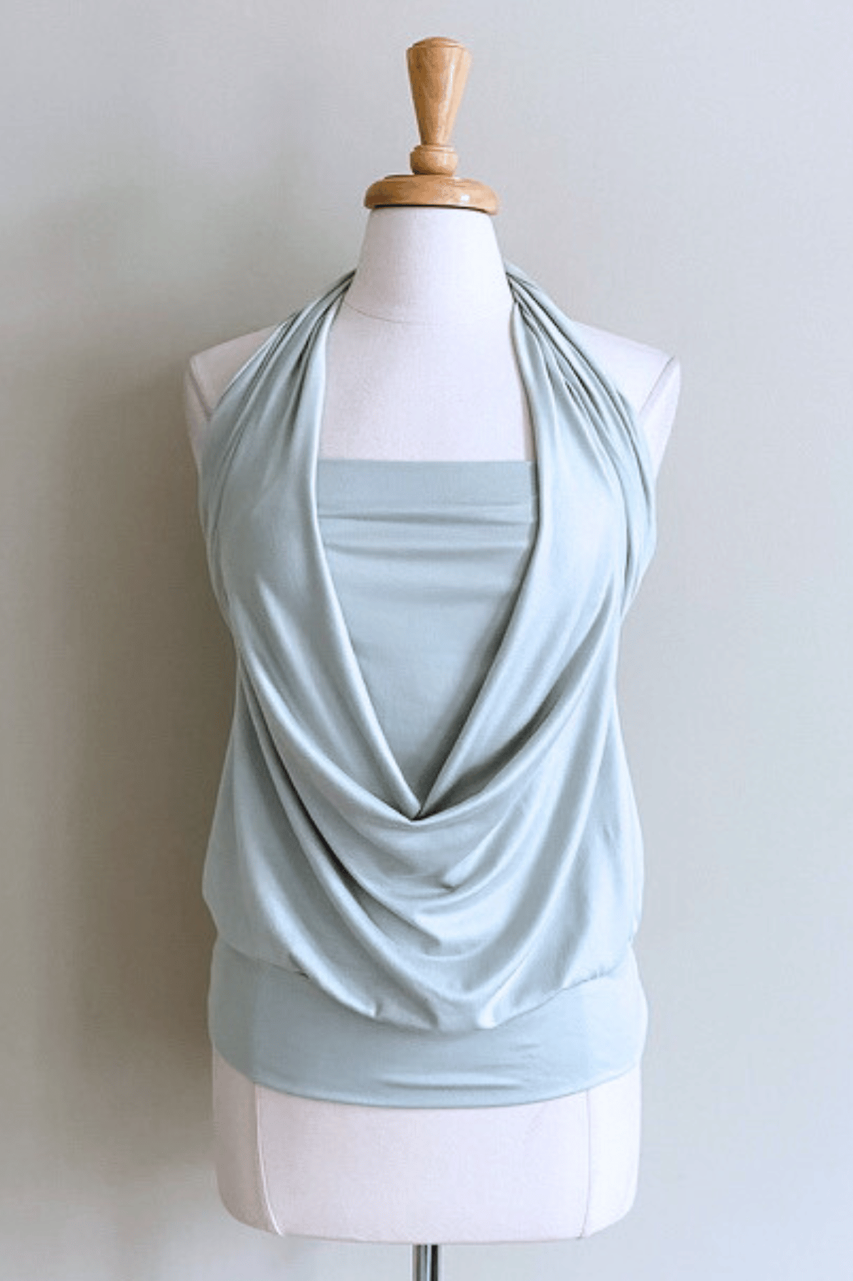 Light green sleeveless top on a mannequin against a plain background
